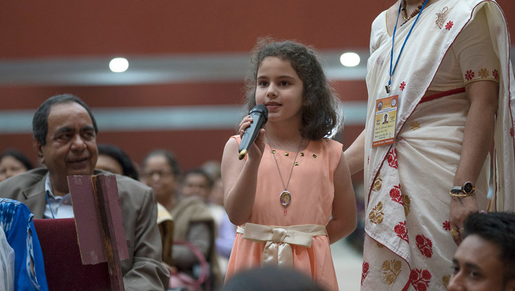 グワハティ大学の講堂で行われた「現代に活かす古代インドの智慧」と題する一般講演で、ダライ・ラマ法王に質問をする幼い少女。2017年4月2日、インド、アッサム州グワハティ（撮影：テンジン・チュンジョル / 法王庁）