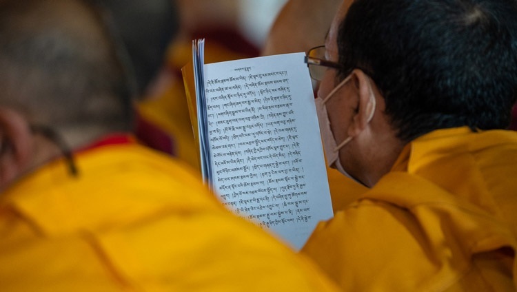 ダライ・ラマ法王によるナーガールジュナの『菩提心の解説』の法話会で、テキストを目で追う僧侶たち。2022年12月30日、インド、ビハール州ブッダガヤ（撮影：テンジン・チュンジョル / 法王庁）